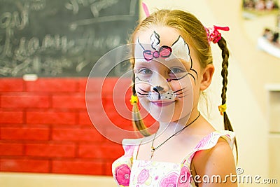 Alchevsk, Ukraine - August 3, 2017: A child draws a face for a children`s party. Aqua makeup for girls and boys. Editorial Stock Photo