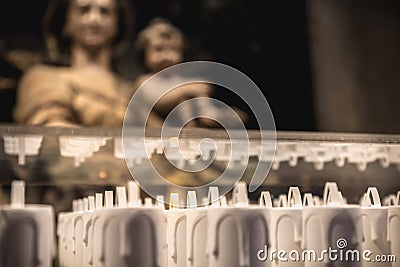 Electric candle in front of the statue of the Blessed Virgin Mary in Alcobaca monastery, Portugal Editorial Stock Photo