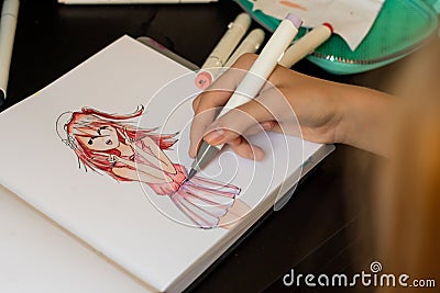 Hand drawing a cute girl anime style sketch with alcohol based sketch drawing markers Editorial Stock Photo