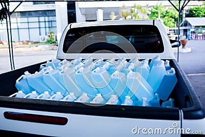 Alcohol for cleaning and sanitizing is contained in gallons on pick-up truck. Many gallon alcohol gel for sanitizing Coronavirus Stock Photo
