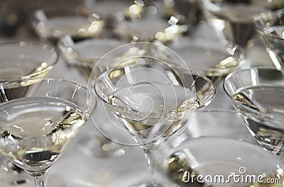 Alcohol cocktails, martini, vodka and others on decorated catering bouquet table on open air event or wedding. Stock Photo