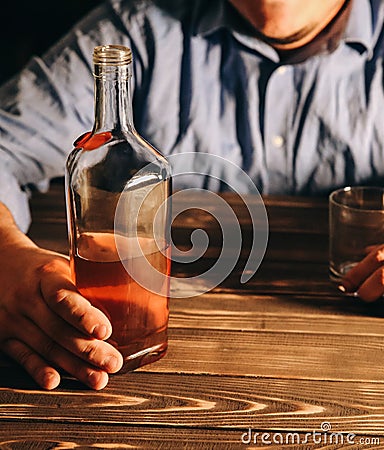 Alcoholic addict. Man holding with alcohol and a glass. Dangerous habit. Unhealthy life concept. Social problem Stock Photo