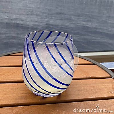 An alcoholic beverage of vodka and lemonade on a table aboard a cruise ship balcony Stock Photo