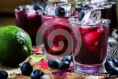 Alcoholic cocktail Darkside, with liqueur, blueberry, lime juice Stock Photo