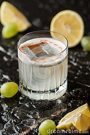 Alcoholic cocktail, fruit and lemon. Photo of drinks on a dark background Stock Photo