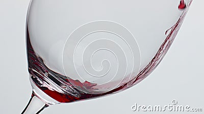 Alcoholic drink pouring clear wineglass closeup. Red wine filling clear glass Stock Photo