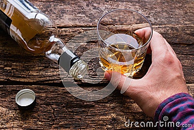 Alcoholic holding a glass of alcohol Stock Photo