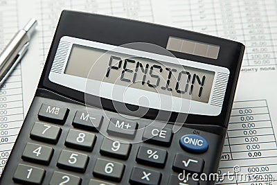 Calculator with the inscription on the PENSION display on the paper tables. Pension calculation Stock Photo