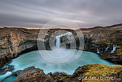 Aldeyjarfoss waterfall in Iceland at sunrise with golden clouds in the sky. Amazing landscape in beautiful tourist attraction. Won Stock Photo