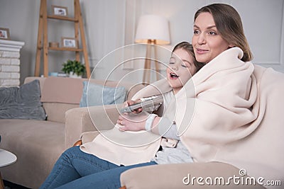 Alert mother and daughter relaxing at home Stock Photo