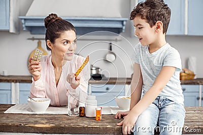 Alert mother talking about vitamins with her dear son Stock Photo