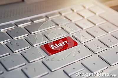 Alert word on red keyboard button, Color button on the gray silver keyboard of modern ultrabook. caption on the button Stock Photo