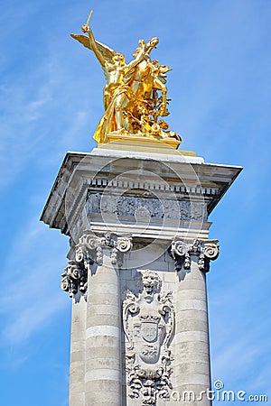 Alexandre III bridge golden statue with winged horse and column, blue sky in Paris, France Stock Photo