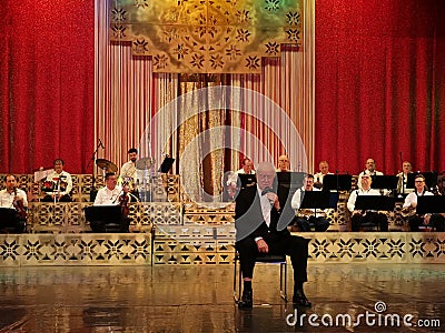 Alexandru Arsinel sitting on a chair on the stage of the Theater Constantin Tanase Editorial Stock Photo