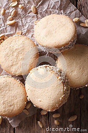 Alfajores cookies on paper close-up on the table. Vertical top v Stock Photo