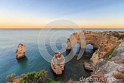 Algarve in Portugal and its amazing beaches, is a summer holiday destination for many tourists in Europe. Landscape with cliffs on Stock Photo