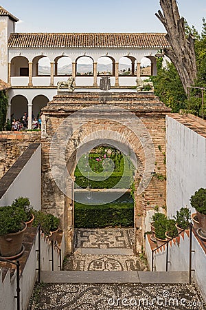 Alhambra. Entrance to the courtyard of the Cypresses. The water and coolness of the Generalife Garden on a hot sunny day Editorial Stock Photo