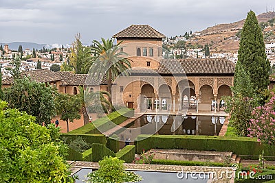 View at the Partal Palace or Palacio del Partal , a palatial structure around gardens and water lake inside the Alhambra fortress Editorial Stock Photo