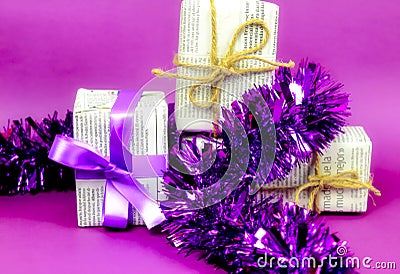 Gifts wrapped in old newspaper on purple background Editorial Stock Photo