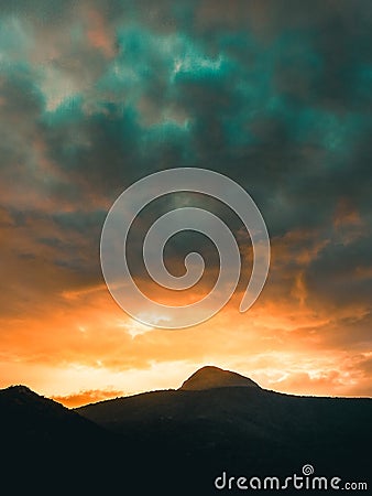Alien sky during a sunset. Mountains Stock Photo