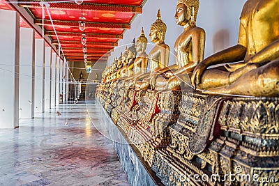 Aligned golden buddha statues Wat Pho temple bangkok Thailand Stock Photo