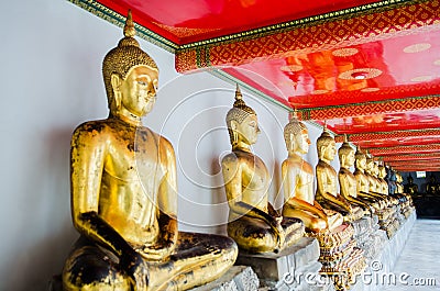 Aligned golden buddha statues Wat Pho temple bangkok Thailand Stock Photo