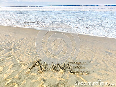 'Alive' Draw On Sandy Beach With Ocean Waves, Inspirational Sand Word Stock Photo