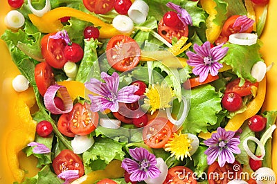 Alkaline, colorful salad with flowers, fruit and vegetables Stock Photo