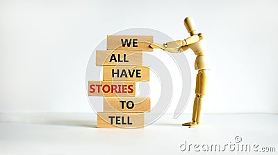 We all have stories to tell symbol. Wooden blocks with words `We all have stories to tell`. Businessman model. Beautiful white Stock Photo