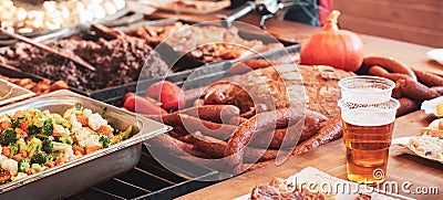 All kinds of delicious tasty food and plastic glasses of beer with foam banner background. Bbq, grill, different kinds of food Stock Photo