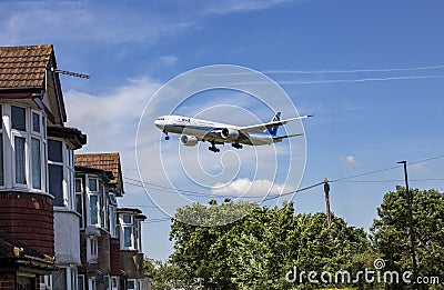 All Nippon Airways Boeing 777 Landing at Heathrow over houses Editorial Stock Photo