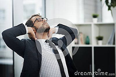 All part of the process of success. a young businessman taking a break in an office. Stock Photo