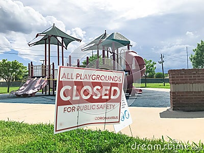 All playgrounds closed for public safety sign as Coronavirus with colorful kid park in background Stock Photo