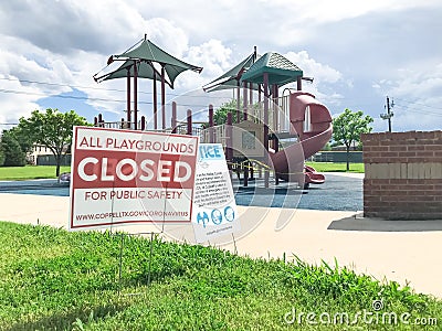 All playgrounds closed for public safety sign as Coronavirus with colorful kid park in background Stock Photo