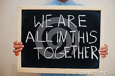 We are all in this together. Coronavirus concept. Boy hold inscription on the board Stock Photo