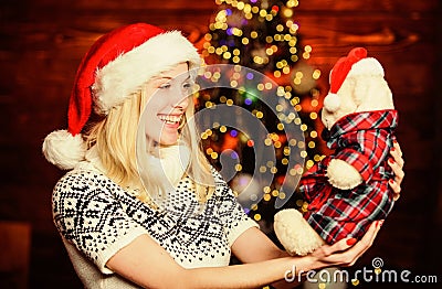 All she wants for christmas. Cheerful woman. Xmas mood. Woman got teddy bear toy present. Santa hat christmas accessory Stock Photo