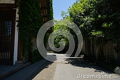 Alley between Chinese traditional building and red brick enclosu Stock Photo