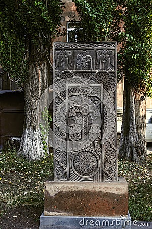 Stone khachkar with the figure of the virgin and child, angels and the Sun-a symbol of eternity in Gyumri Stock Photo