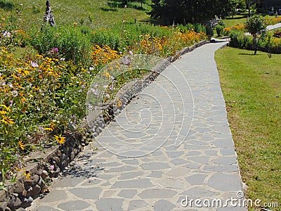 Alley and flowers at Barsana orthodox monastery, Maramures Stock Photo