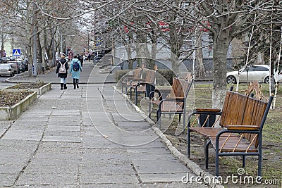 Alley in the spring park. Girls walk along the alley Editorial Stock Photo