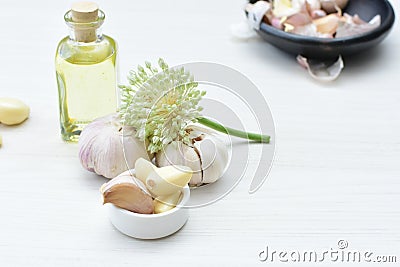 Allium sativum - Whole and minced garlic accompanied by garlic oil Stock Photo