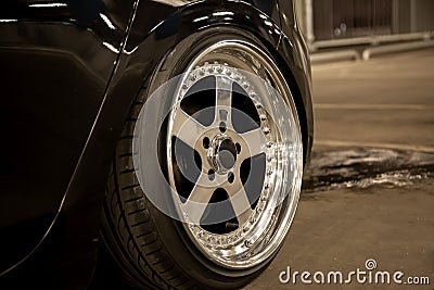 Alloy polished rims of a sports car. Wide wheels with stretched tires. Tuned low car Stock Photo