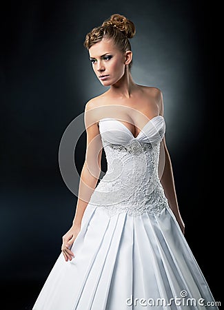 Alluring bride in bridal white dress studio shot Stock Photo