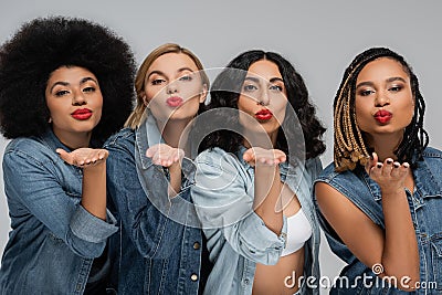 alluring multiracial girlfriends blue denim outfits Stock Photo