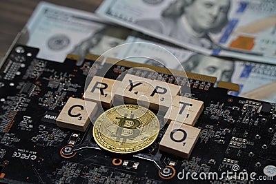Almaty, Kazakhstan - 04.04.2023 : The bitcoin coin and the crypto inscription are spread out on the video card Editorial Stock Photo