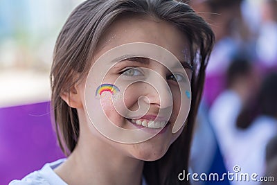 ALMATY, KAZAKHSTAN - JUNE 10, 2018: Unidentified girl makeup artist makes a bright carnival face painting to the Editorial Stock Photo