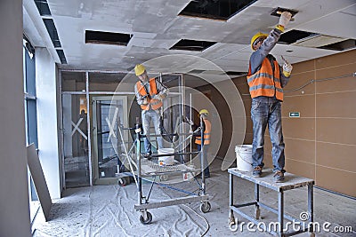 Almaty, Kazakhstan - 11.03.2015 : Workers carry out repair and construction work in the building Editorial Stock Photo