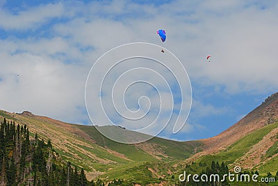 Almaty mountains with paraplane flying in the sky Stock Photo