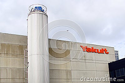Yakult wall logo and factory silo. Editorial Stock Photo