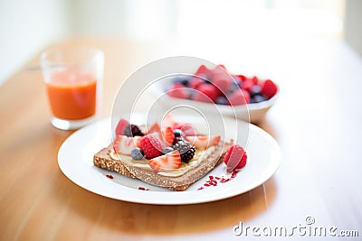 almond butter toast with red berry garnish, on a white table Stock Photo
